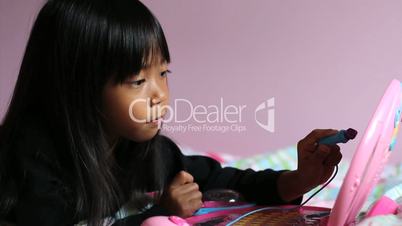 Asian Girl Using Pink Laptop Computer