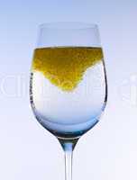 Olive oil stirred into wine glass