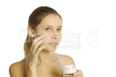 Beautiful girl holding cream