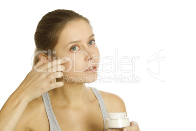 Beautiful girl holding cream