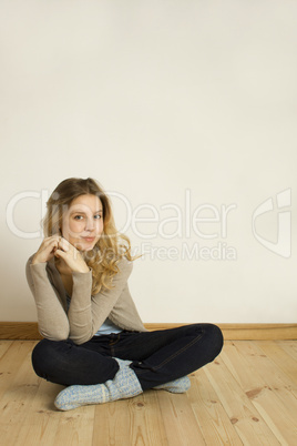 Young woman sitting on the floor at home
