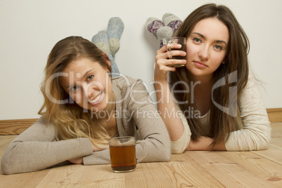 Two attractive friends drinking tea