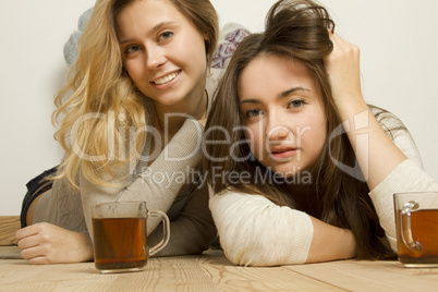 Two attractive friends drinking tea