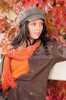 Autumn park bench young woman relaxing