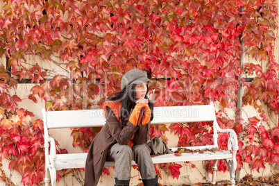 Autumn park bench young woman relaxing