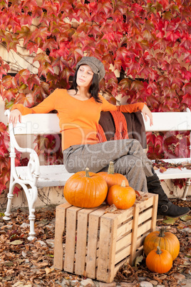 Autumn park bench young woman with pumpkins