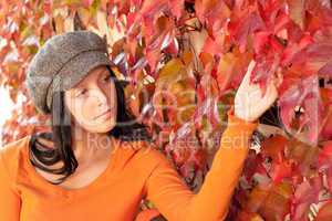 Autumn park bench young woman touch leaf