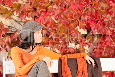 Autumn fashion young woman relax on bench