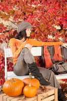 Autumn park bench young woman with pumpkins