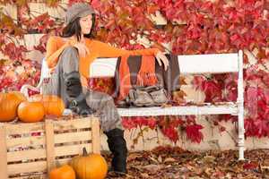 Autumn park bench young woman with pumpkins