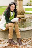 Autumn park bench young woman hold phone