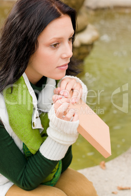 Autumn fountain young woman read book