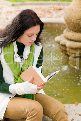 Autumn fountain young woman read book