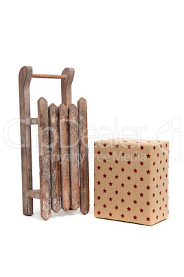 old wooden sledge with gift an white