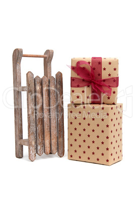 old wooden sledge with gift an white