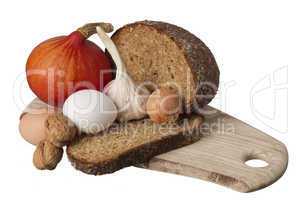 brown bread on shelf with onion, garlic and walnut
