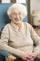 Senior Woman Relaxing In Chair At Home