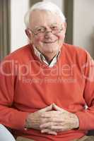 Senior Man Relaxing In Chair At Home