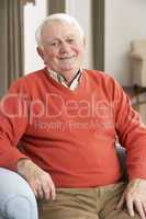 Senior Man Relaxing In Chair At Home