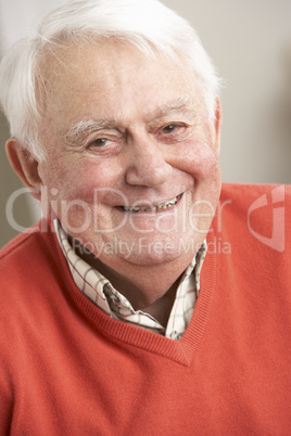 Senior Man Relaxing In Chair At Home