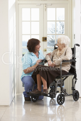 Carer With Disabled Senior Woman Sitting In Wheelchair