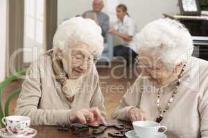 Two Senior Women Playing Dominoes At Day Care Centre