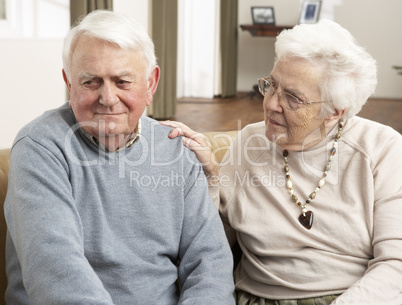 Senior Woman Consoling Husband At Home