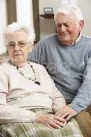 Senior Man Consoling Wife At Home