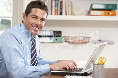 Man Working From Home Using Laptop