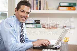 Man Working From Home Using Laptop