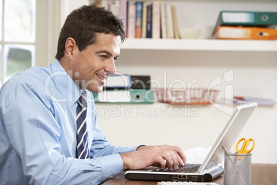 Man Working From Home Using Laptop