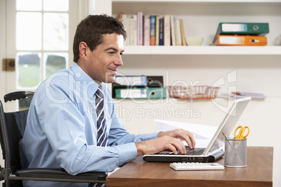 Man Working From Home Using Laptop