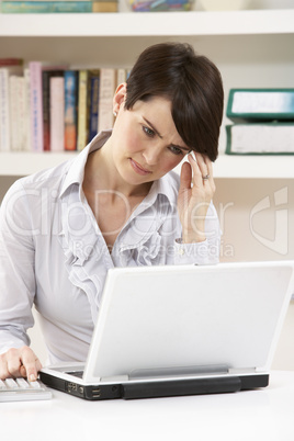 Worried Looking Woman Working From Home Using Laptop