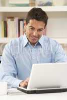 Man Working From Home Using Laptop