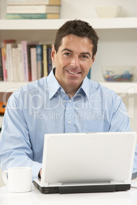 Man Working From Home Using Laptop