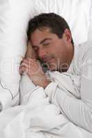 Man Sleeping Peacefully In Bed