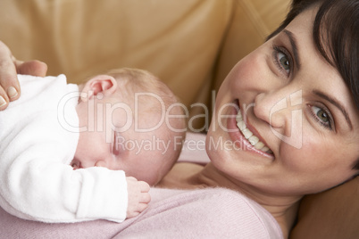 Portrait Of Mother With Newborn Baby At Home