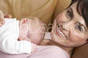 Portrait Of Mother With Newborn Baby At Home