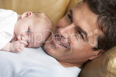 Portrait Of Father With Newborn Baby At Home