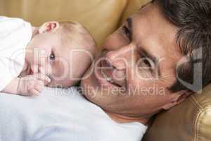 Portrait Of Father With Newborn Baby At Home