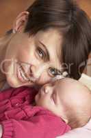 Portrait Of Mother With Newborn Baby At Home