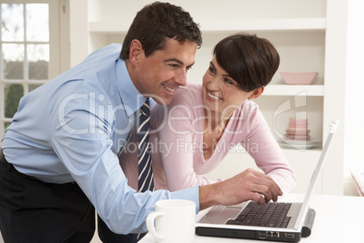 Couple Working From Home Using Laptop