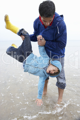Happy father with son on beach