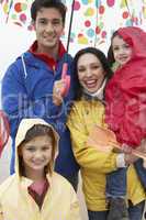 Happy family on beach with umbrella