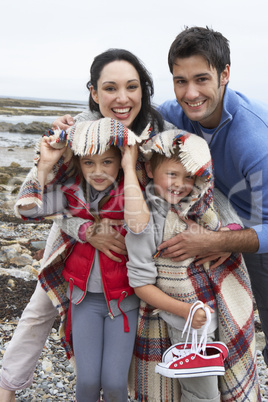 Family on beach with blankets