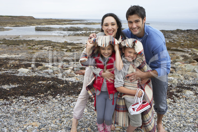 Family on beach with blankets
