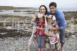 Family on beach with blankets