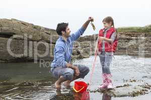 Father with daughter on beach