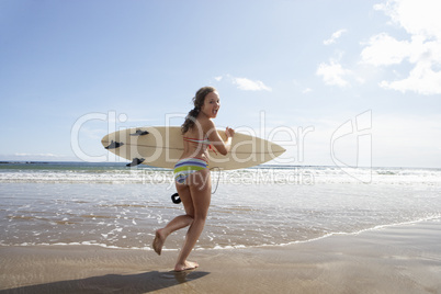 Teenager girl with surfboard