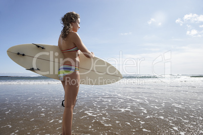 Teenager girl with surfboard